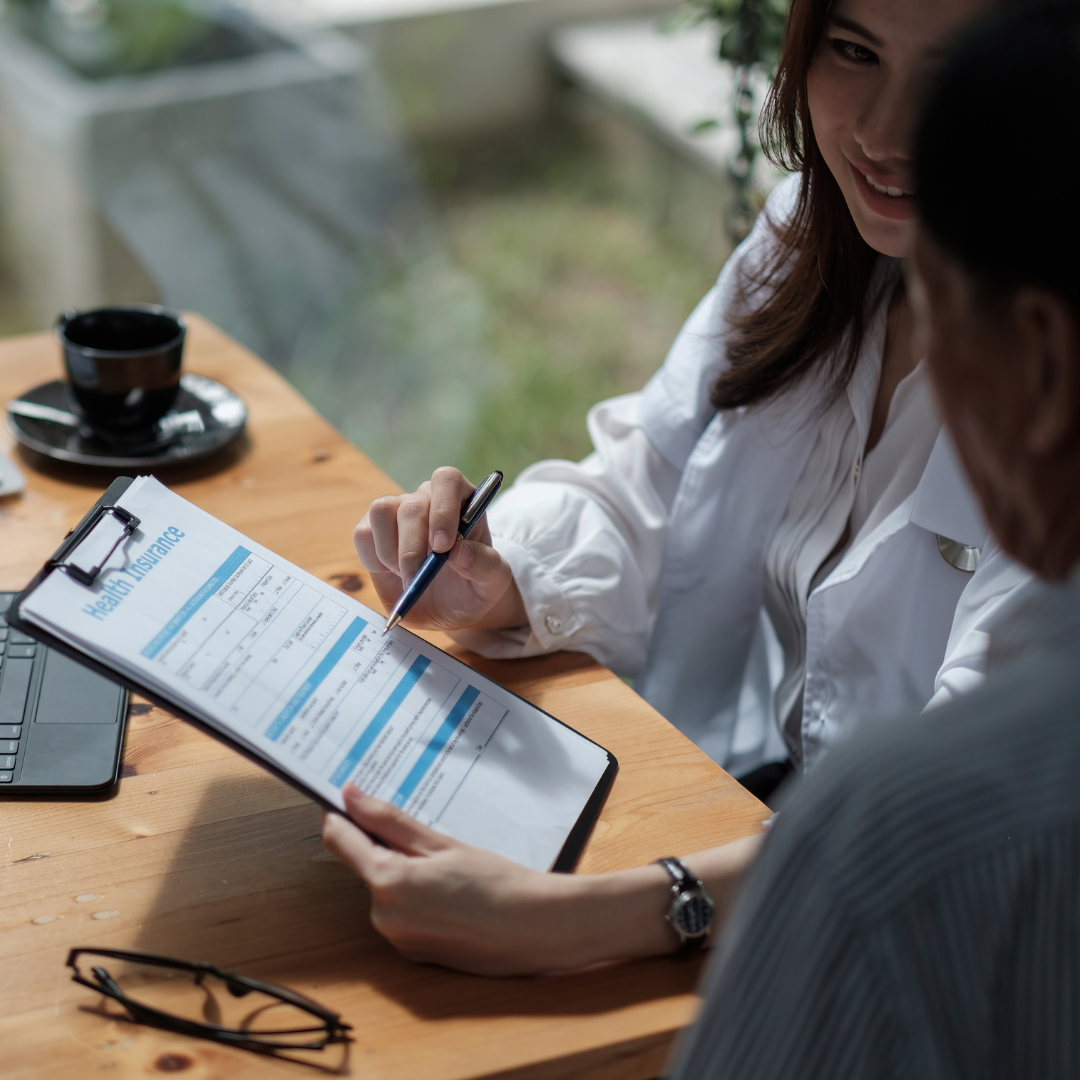 Health Insurance Featured Image. Doctor showing a clipboard to a person.